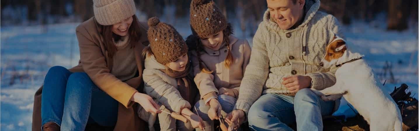 family roasting marshmallows outside