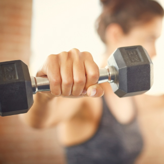 Woman working out with hand weight.