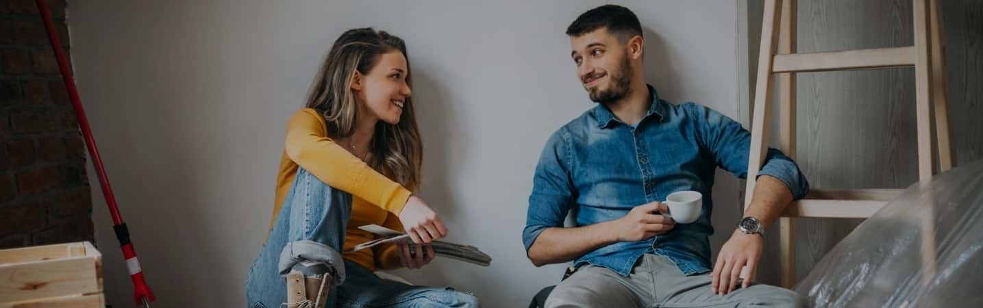 Young couple painting a room