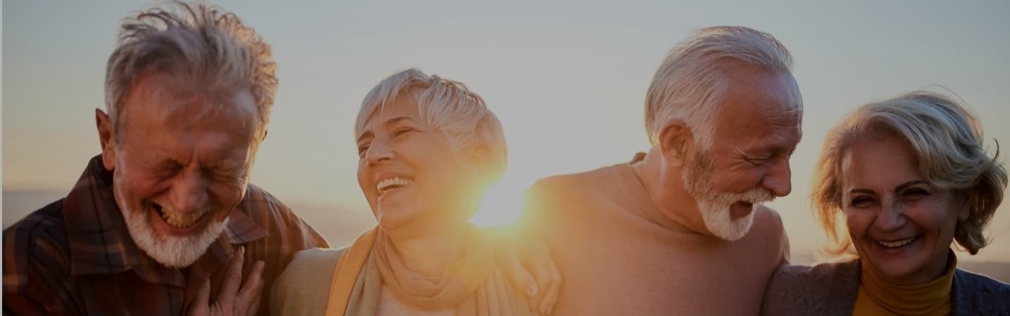 Four mature adults sharing a laugh