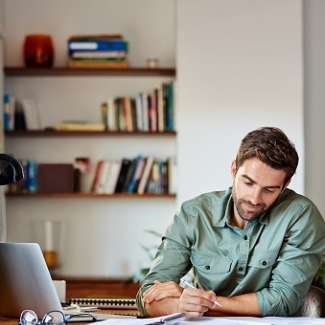 Young many working at a desk