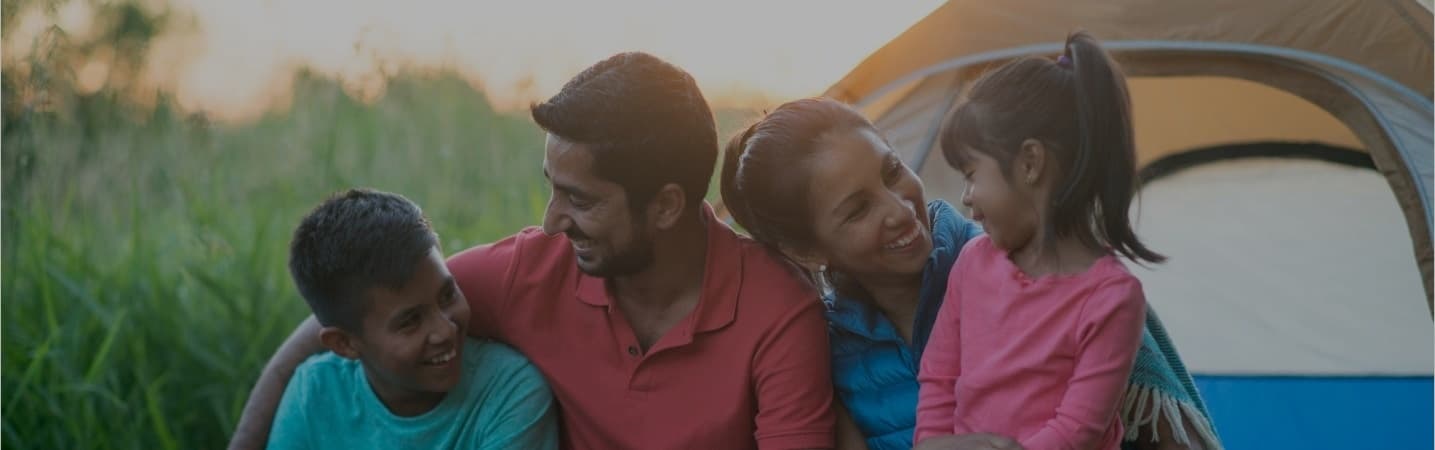 Young hispanic family camping.