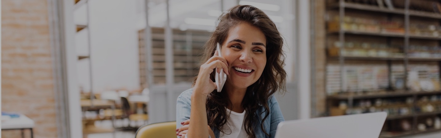 Happy young businesswoman on her phone