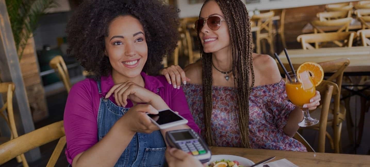 two young females enjoying breakfast at a cafe