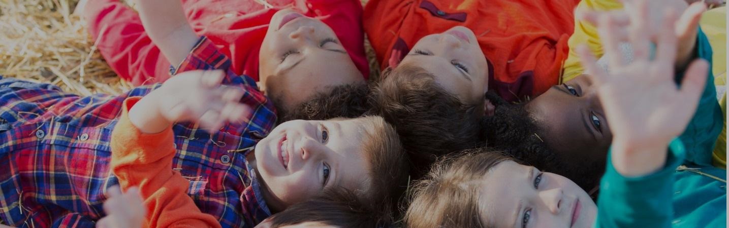 circle of multiethnic children lying on the crass