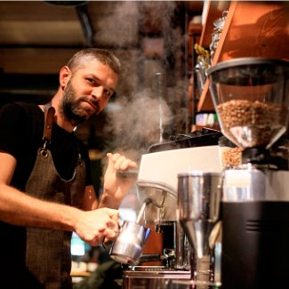 Barista making coffee at cafe