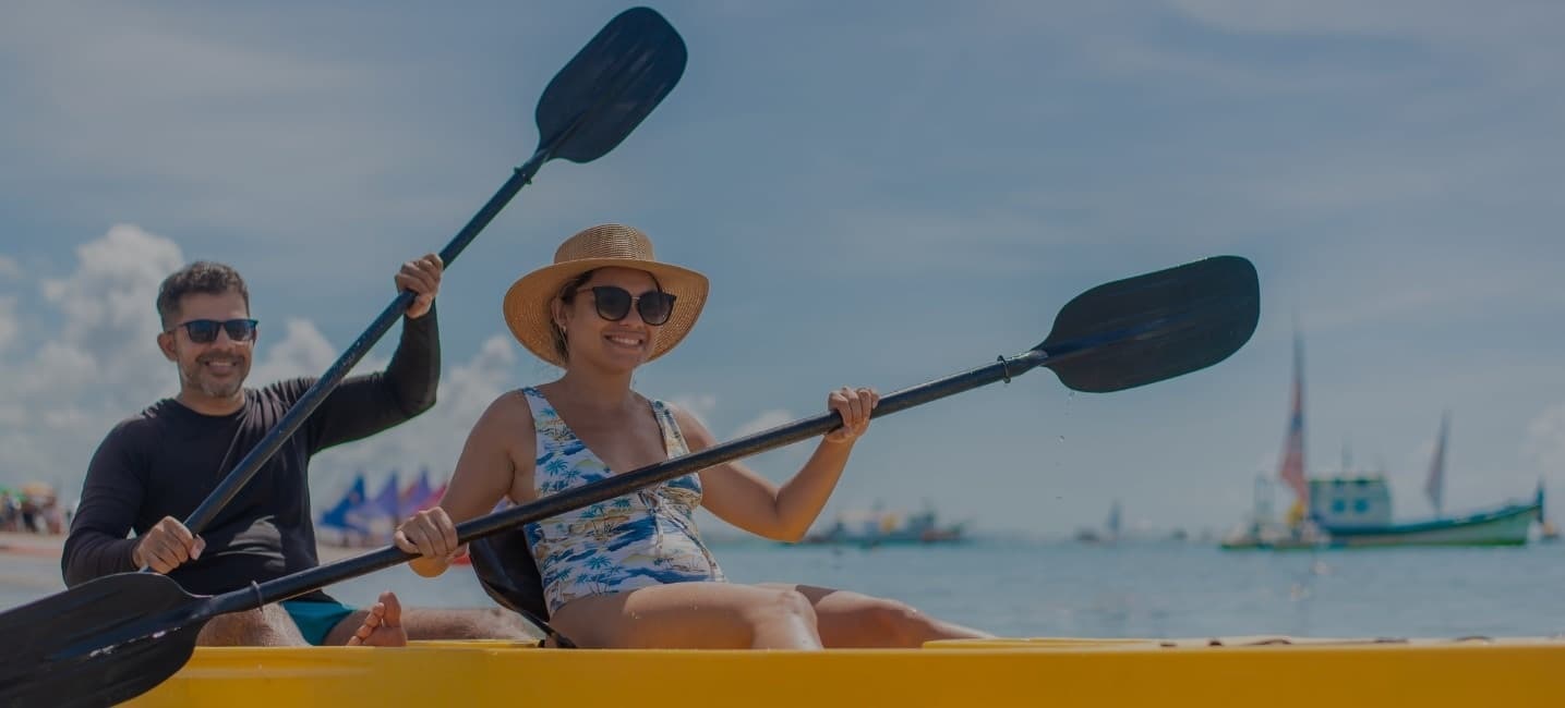 smiling couple enjoying kayaking