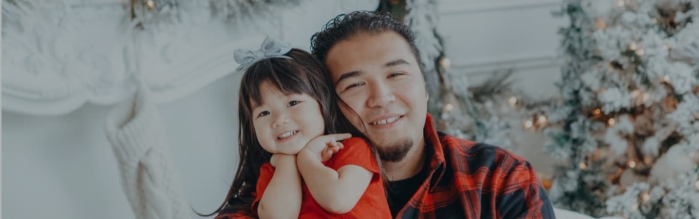 Cute Asian girl and father at home during holidays