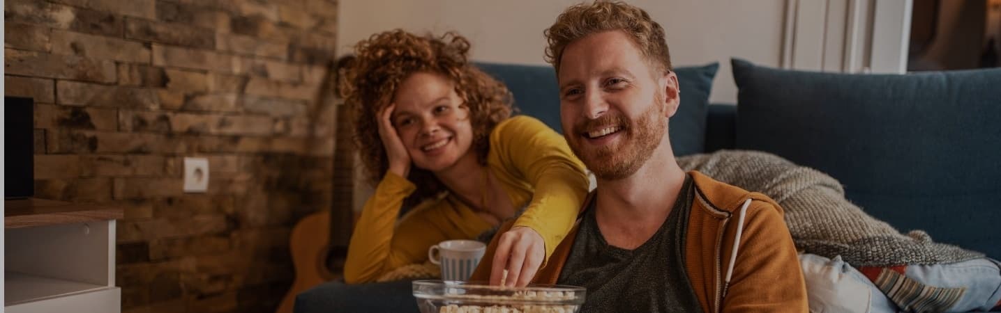 Happy young couple watching a movie