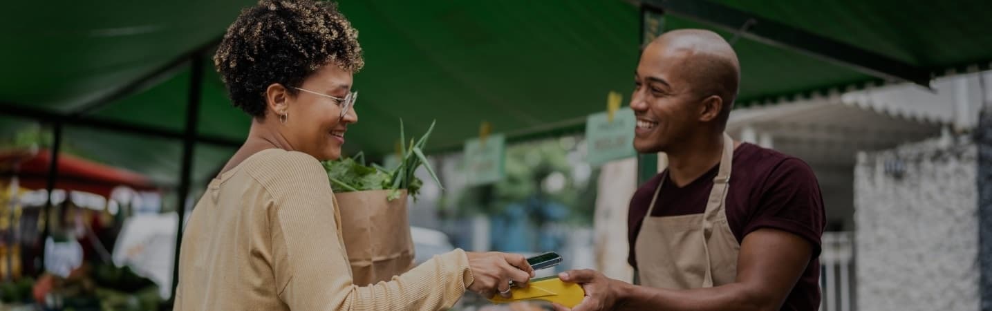 Business associate assisting a customers at checkout