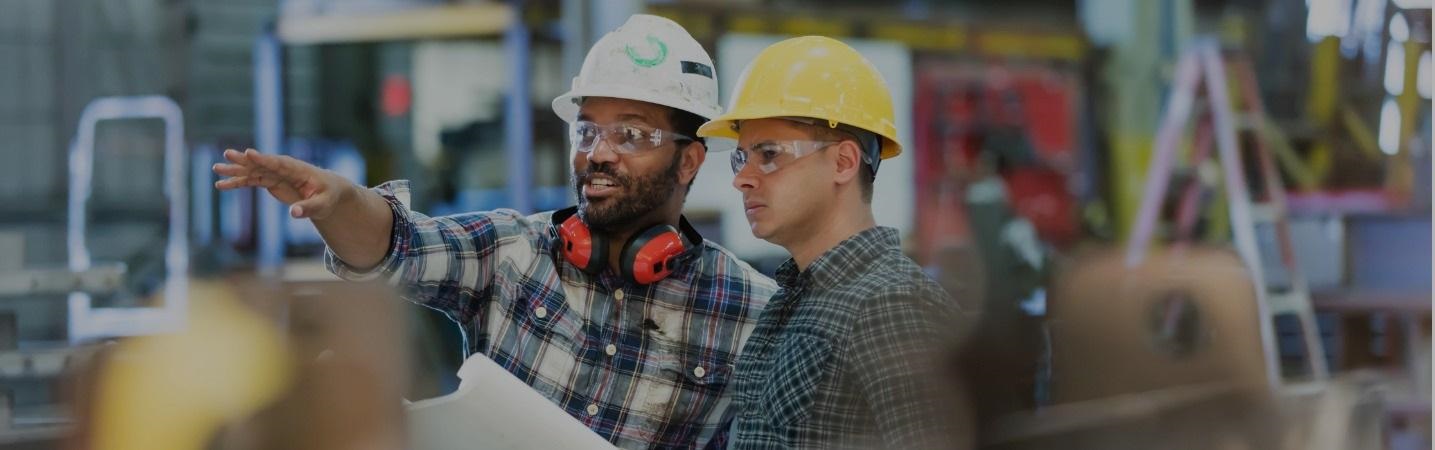 multienthnic workers talking in a metal fabrication plant