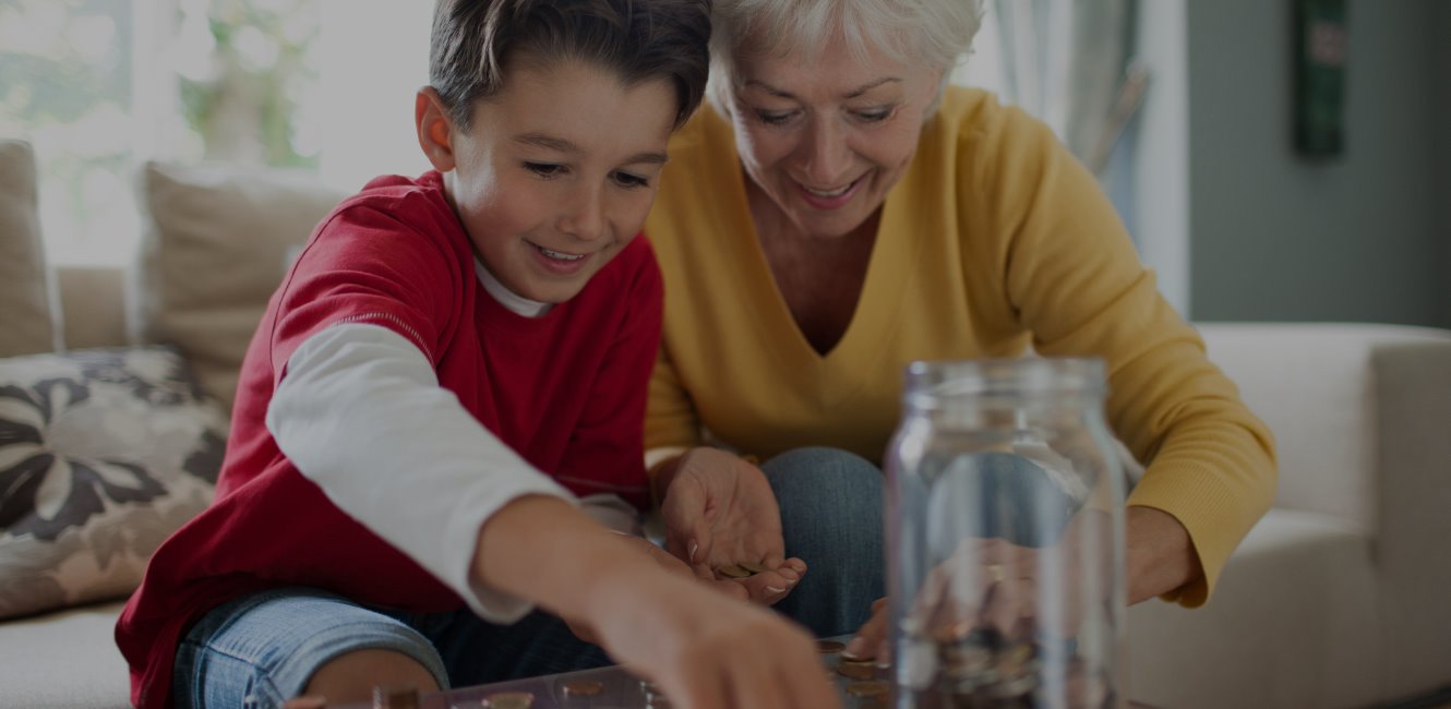 Grandmom and grandson counting change for savings jar
