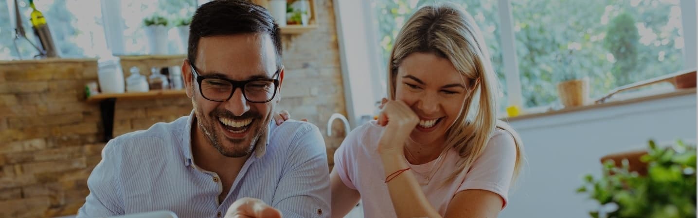 Young couple sharing a laugh over breakfast