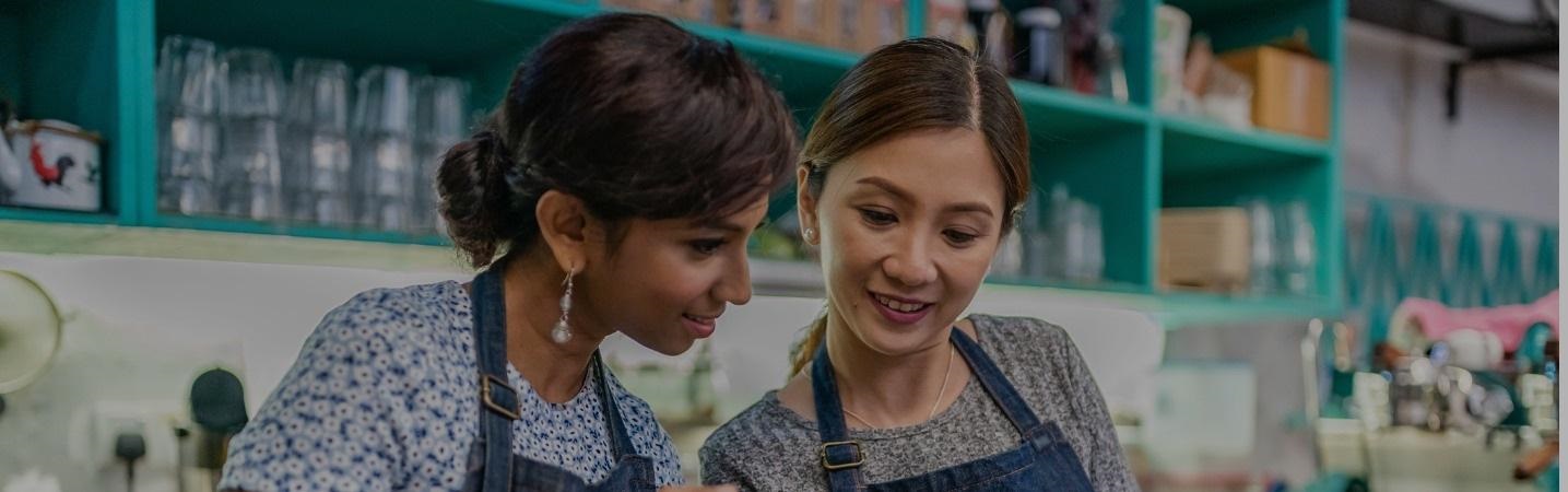 coffee shop waitress checking cash register in restaurant