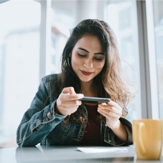 Young woman depositing a check with her mobile phone