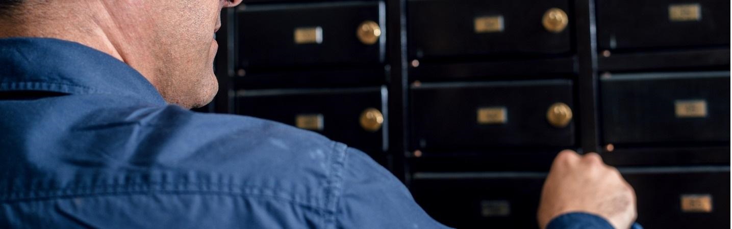 man opening safe deposit box