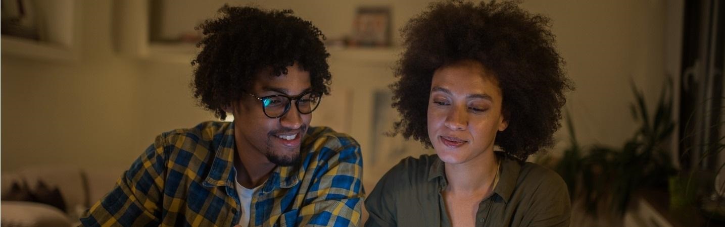 Young couple using a tablet at home