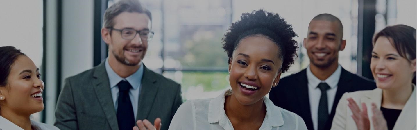 Co-workers applauding co-worker on an accomplishment