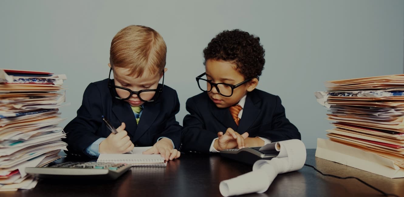 Two boys dressed like financial advisors