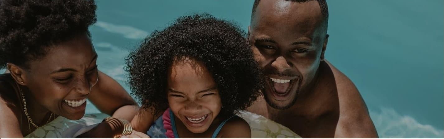 Young African American family in a pool