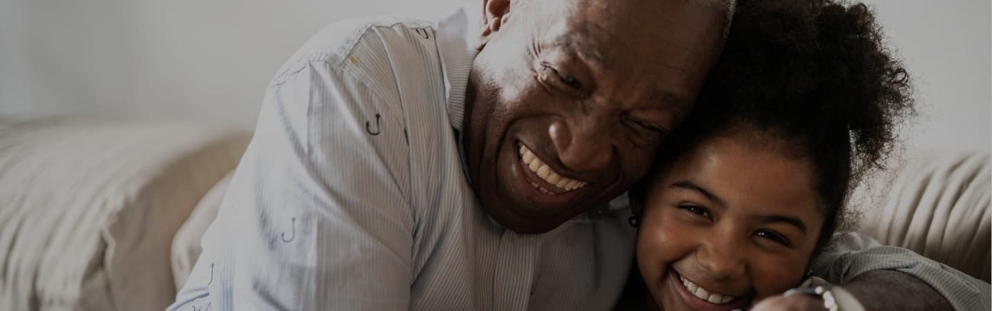 African American grandfather giving his granddaughter an embrace