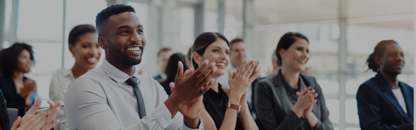 group of young professionals applauding at a seminar