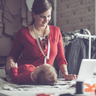 Mom working at home with her baby.