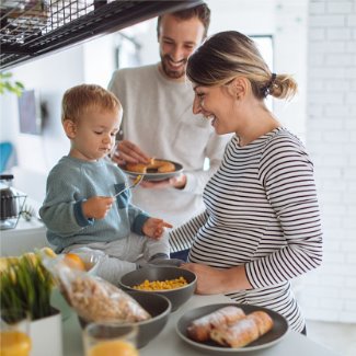 Young family preparing breakfast together