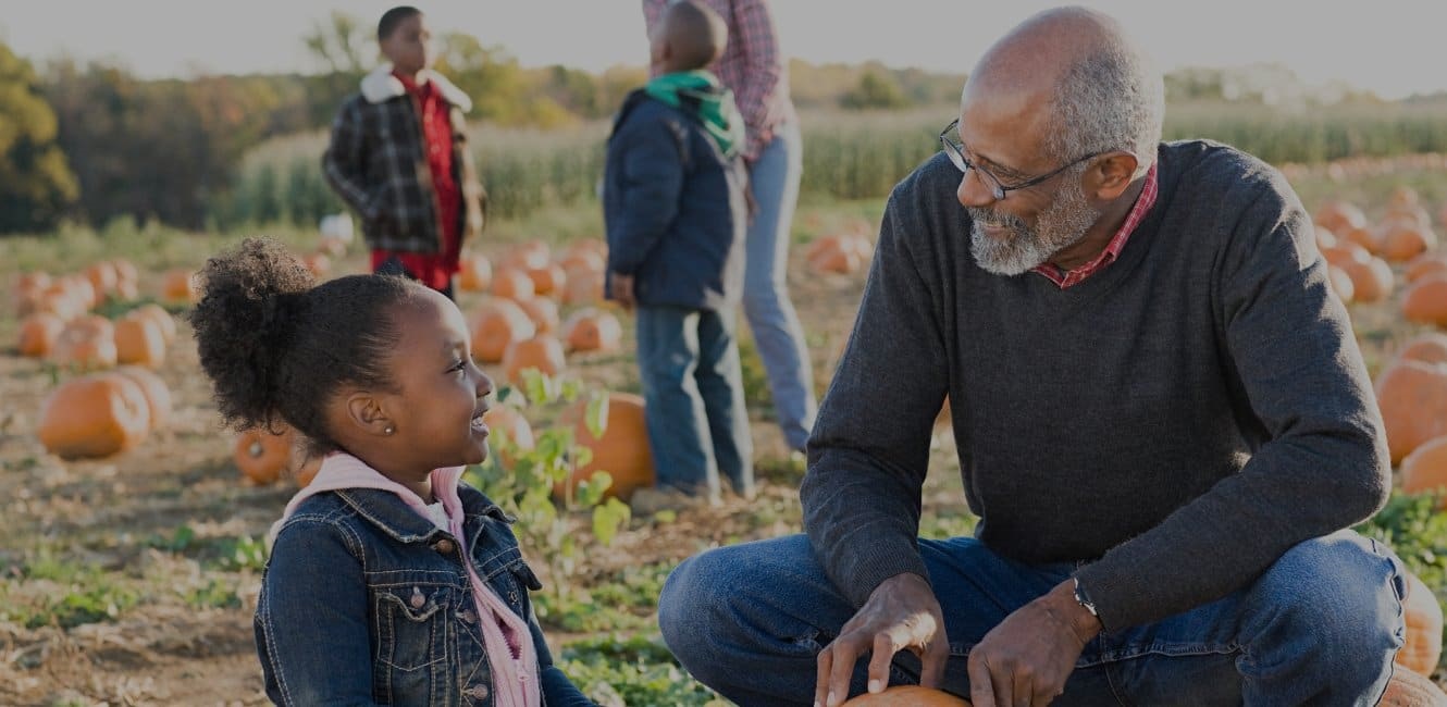 Grandfather and granddaughter at the pumpkin patch
