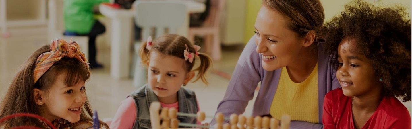 Preschool teacher teaching children how to use an abacus