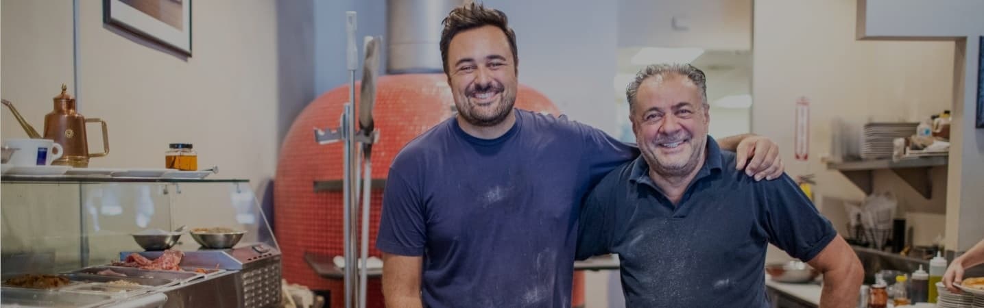 Deli business owners smiling for the camera