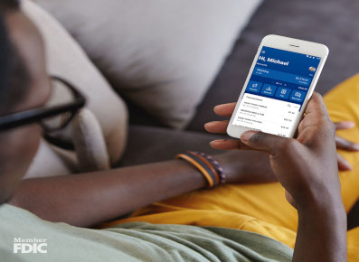 Woman using mobile banking app at home