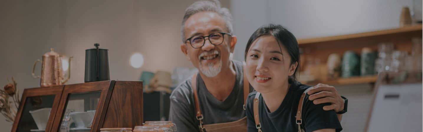 Asian male cafe owner and his daughter