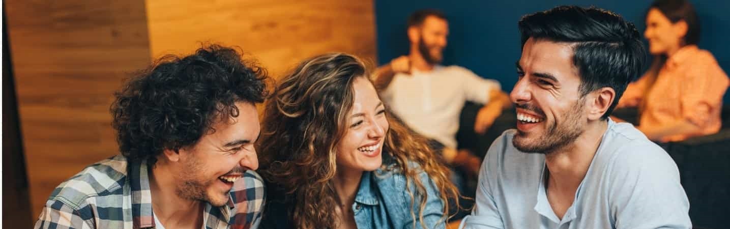 friends sharing a laugh at a cafe