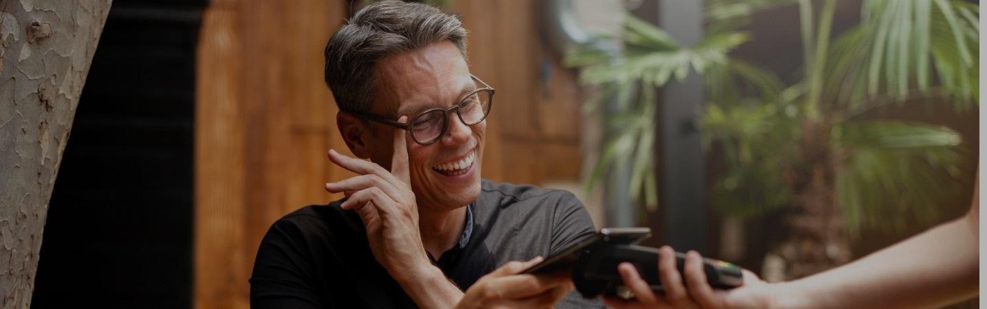 Man paying using contactless payment with phone