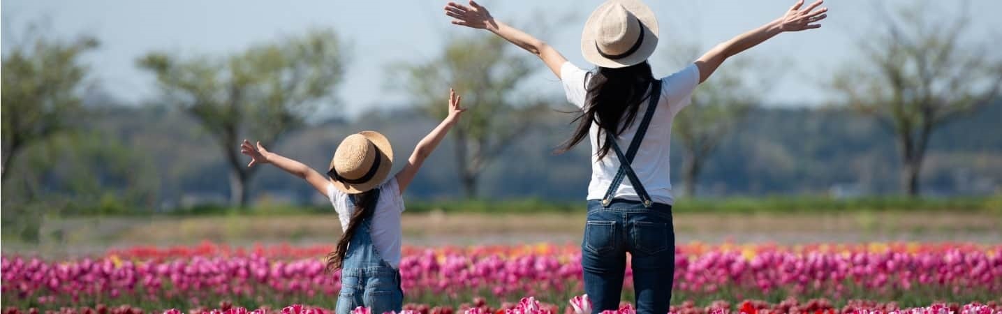 Mother and daughter in a flower field celebrating spring