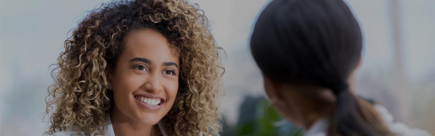 two young business women meeting for the first time