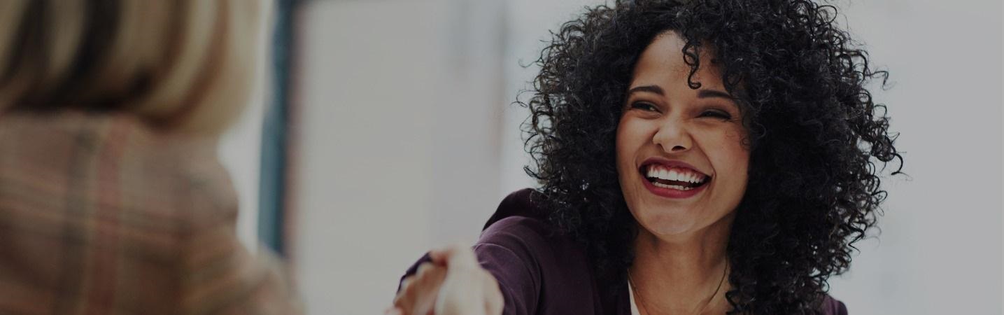 business woman welcoming a co-worker into office