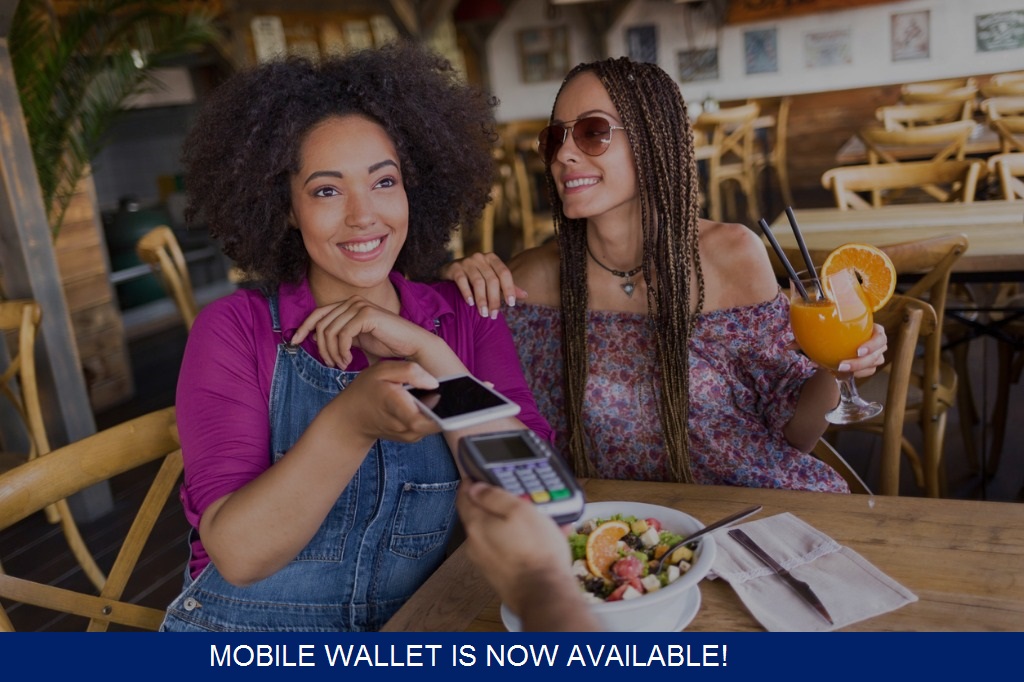 cheerful friends using contactless payment