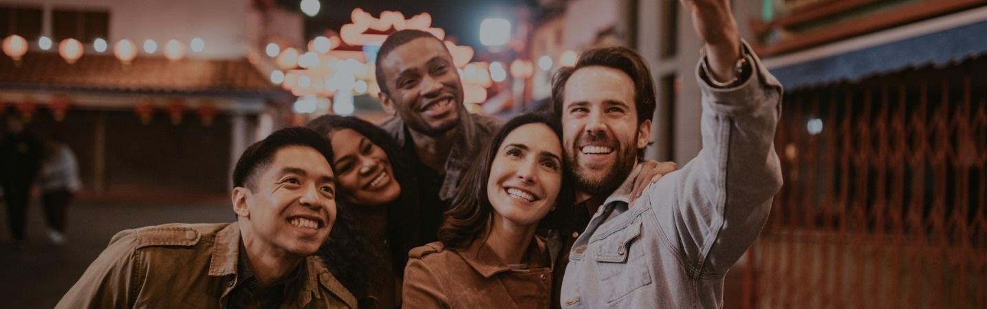 Group of friends taking a selfie in downtown Los Angeles at night