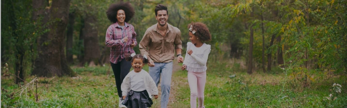Carefree family having fun while running on a spring day outdoors