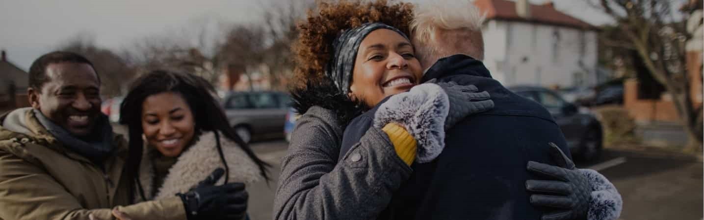 Family meeting in the street hugging
